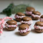 Chocolate Peppermint Macarons: a delicious combination of chocolate and candy cane peppermint! Perfect as a holiday gift or dessert. Recipe via MonPetitFour.com