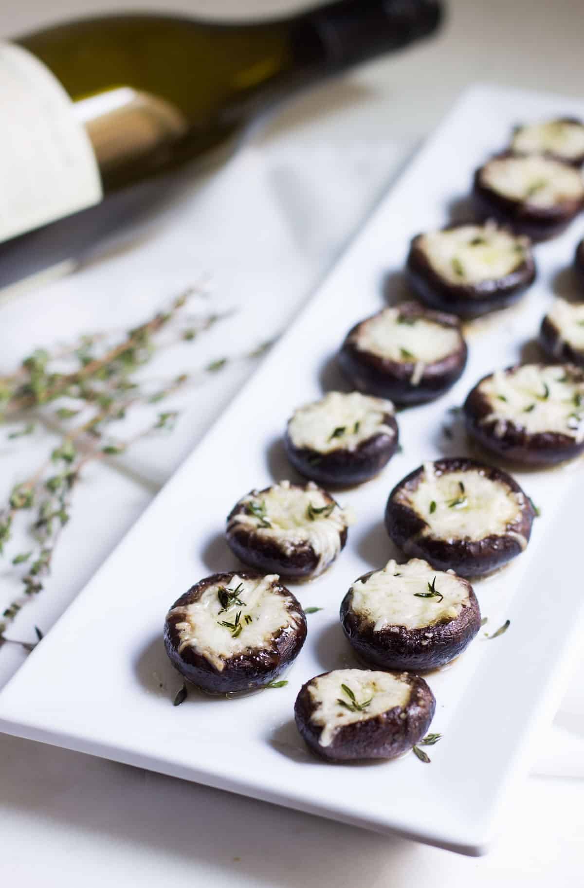 Garlic Stuffed Mushrooms: crimini mushrooms stuffed with garlic butter and parmesan cheese. Perfect appetizer or side dish! French recipe via MonPetitFour.com