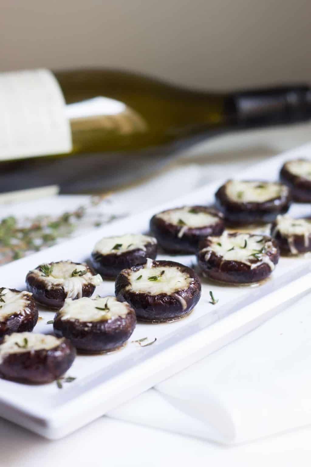 Garlic Stuffed Mushrooms: crimini mushrooms stuffed with garlic butter and parmesan cheese. Perfect appetizer or side dish! French recipe via MonPetitFour.com