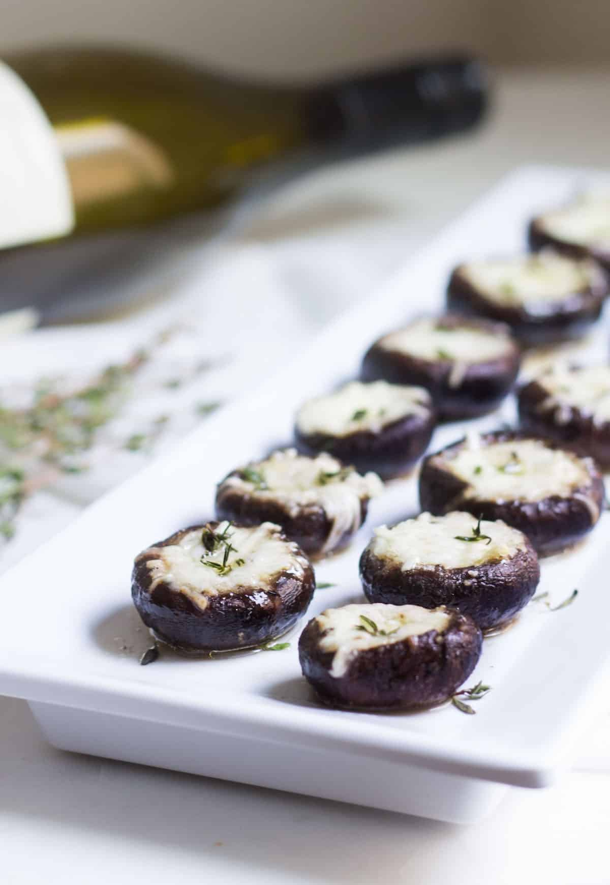 Garlic Stuffed Mushrooms: crimini mushrooms stuffed with garlic butter and parmesan cheese. Perfect appetizer or side dish! French recipe via MonPetitFour.com