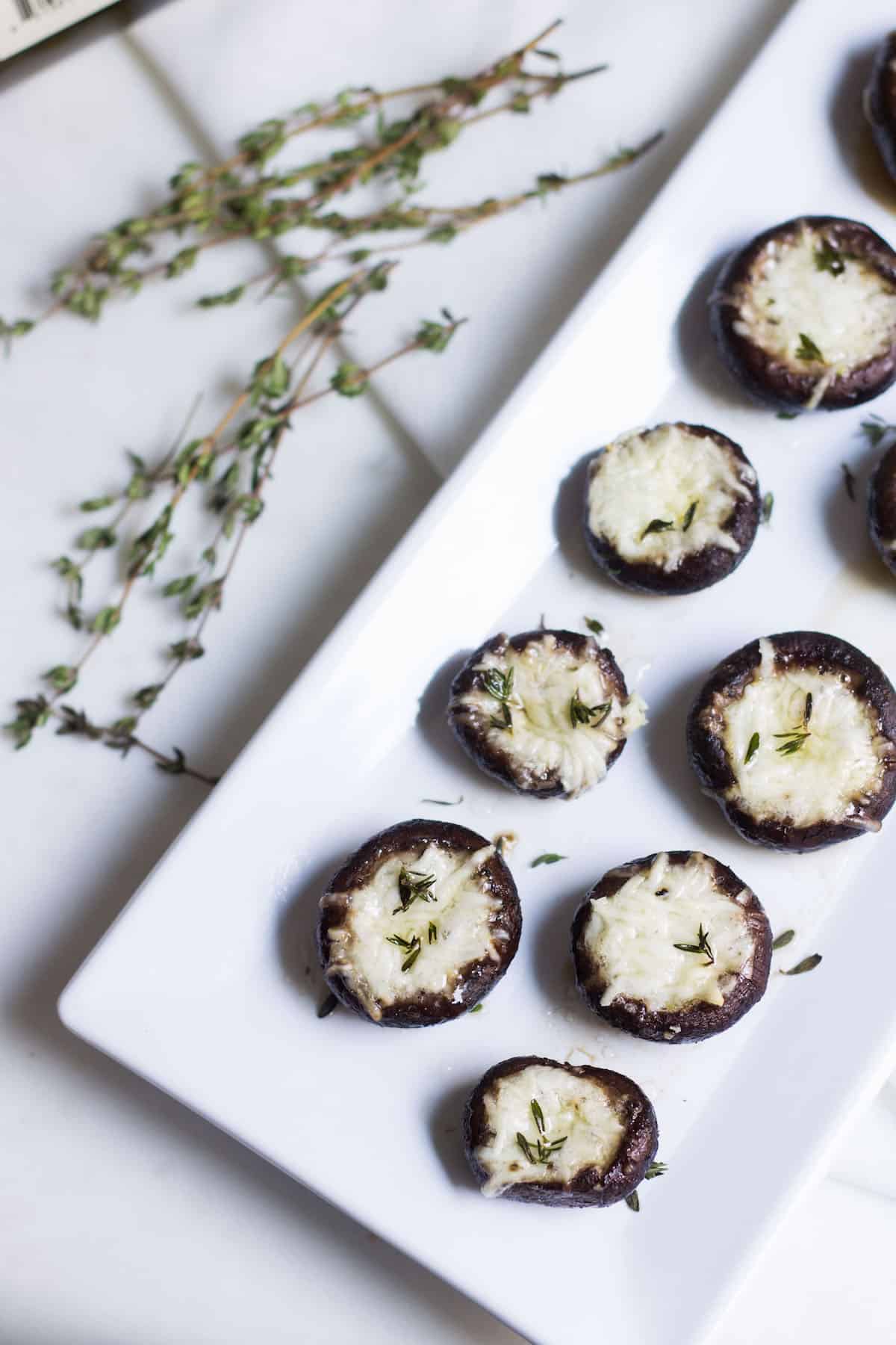 Garlic Stuffed Mushrooms: crimini mushrooms stuffed with garlic butter and parmesan cheese. Perfect appetizer or side dish! French recipe via MonPetitFour.com
