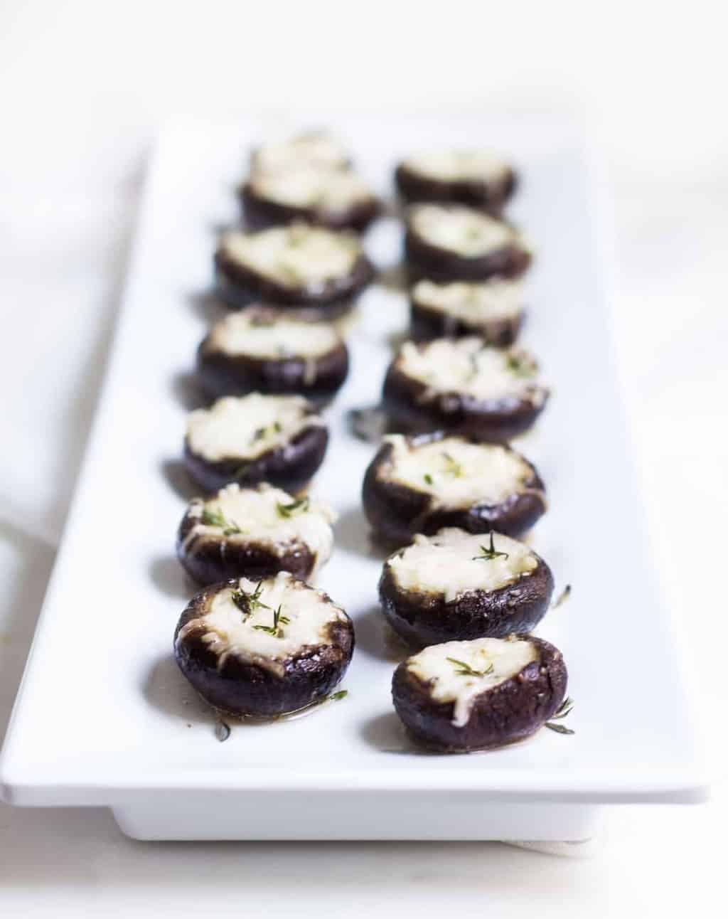 Garlic Stuffed Mushrooms: crimini mushrooms stuffed with garlic butter and parmesan cheese. Perfect appetizer or side dish! French recipe via MonPetitFour.com