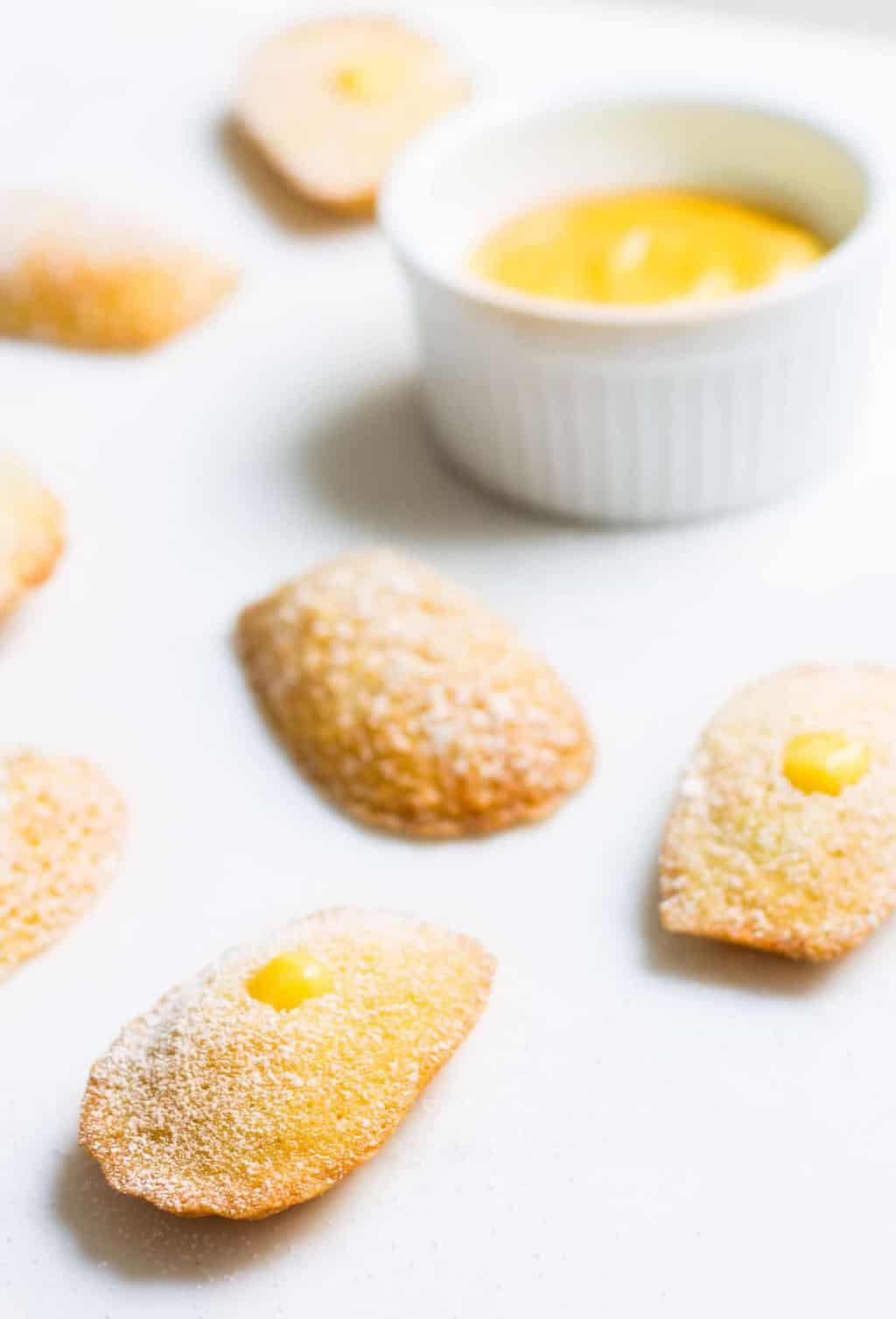 Madeleines with Lemon Curd: sweet little French cakes filled with delicious lemon curd. Recipe via MonPetitFour.com