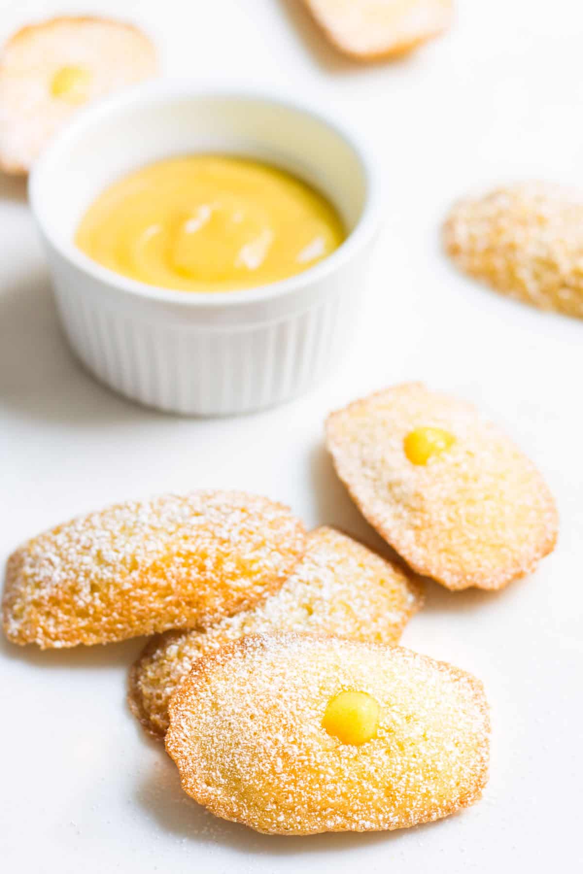 Madeleines with Lemon Curd: sweet little French cakes filled with delicious lemon curd. Recipe via MonPetitFour.com