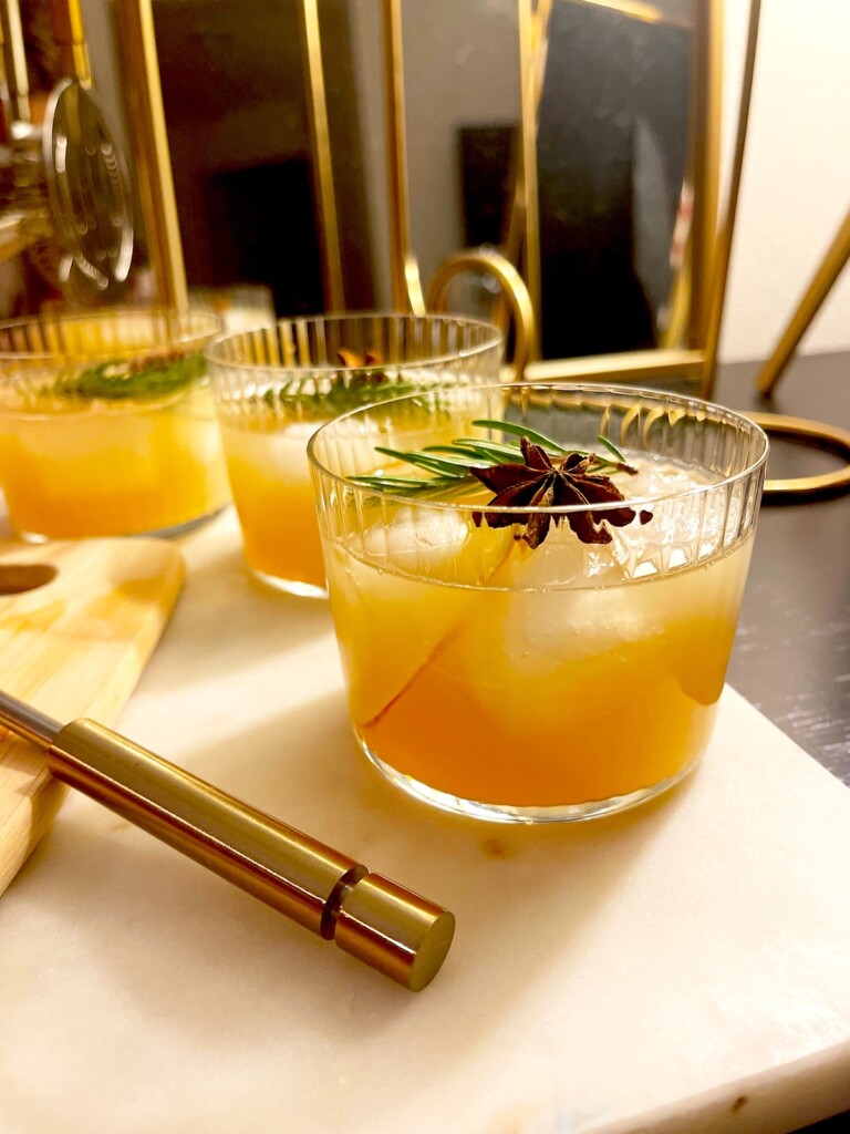 spiced apple cider cocktail recipe with garnishes