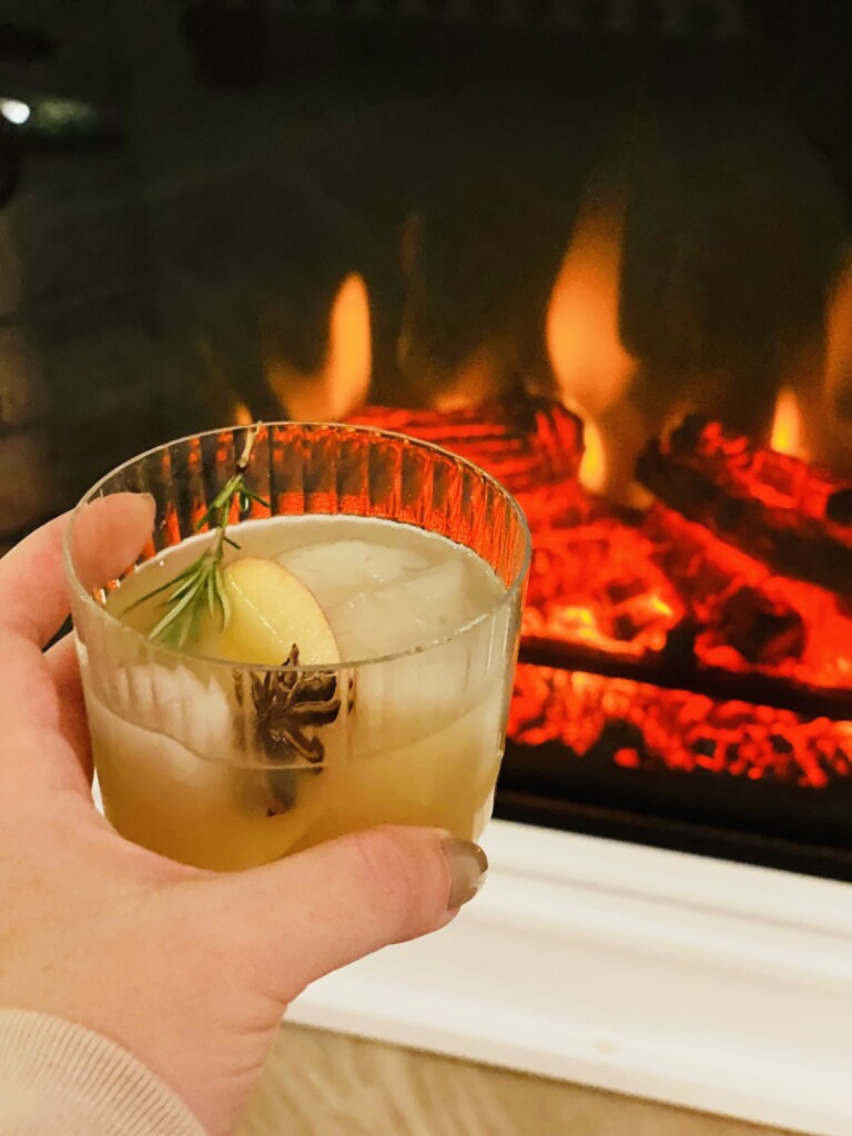 spiced apple cider cocktail in front of the fire