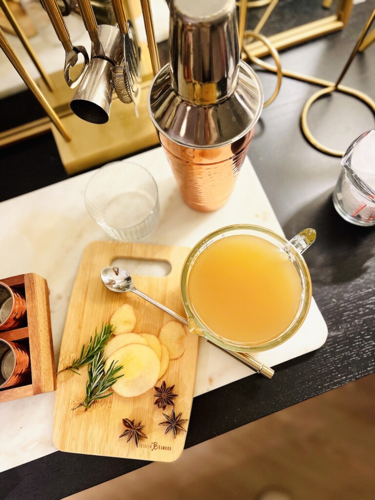 preparing spiced apple cider cocktail
