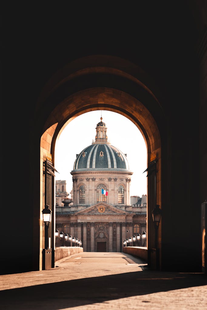 Captivating view of the Institut de France through an archway in Paris, France.