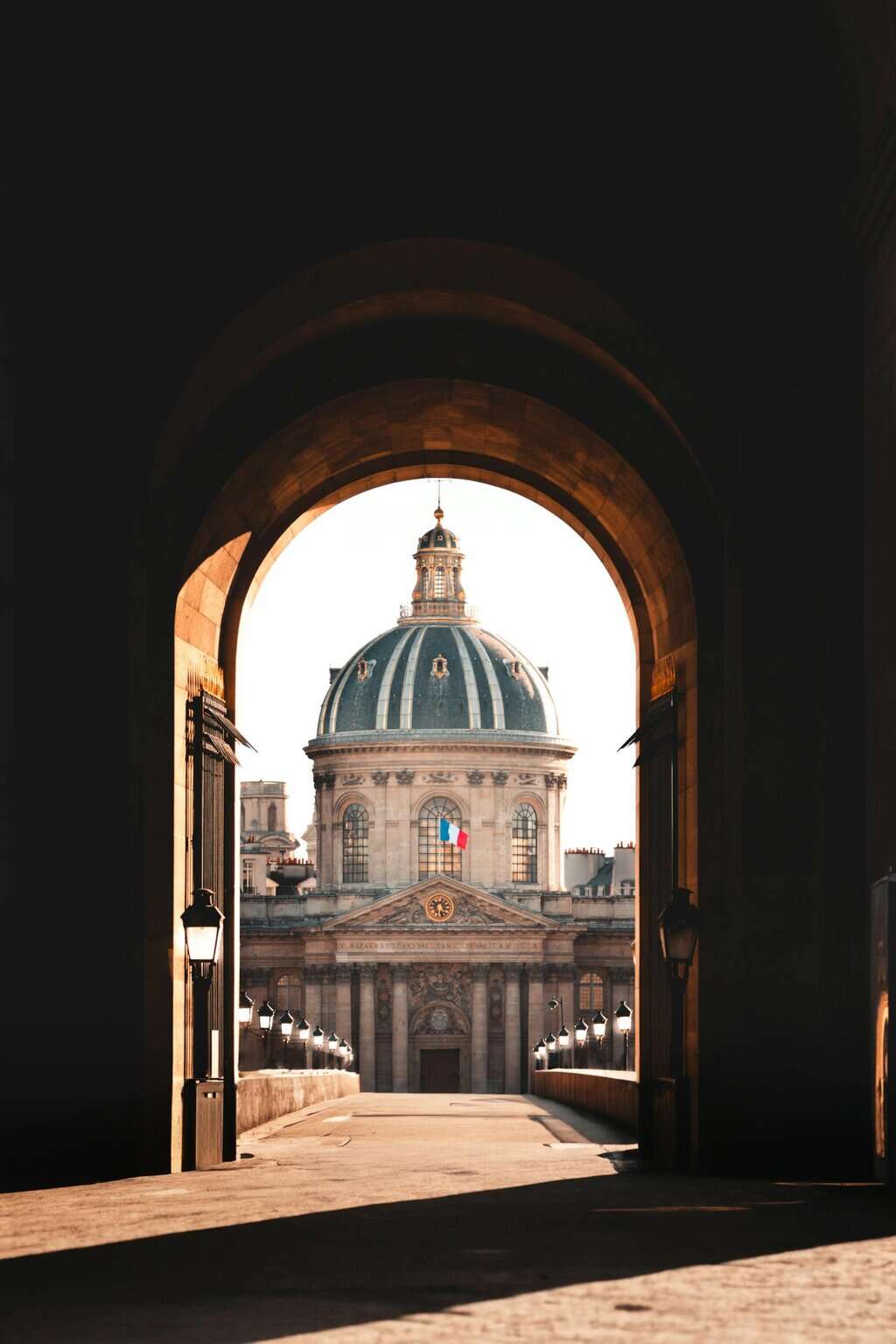 Captivating view of the Institut de France through an archway in Paris, France.