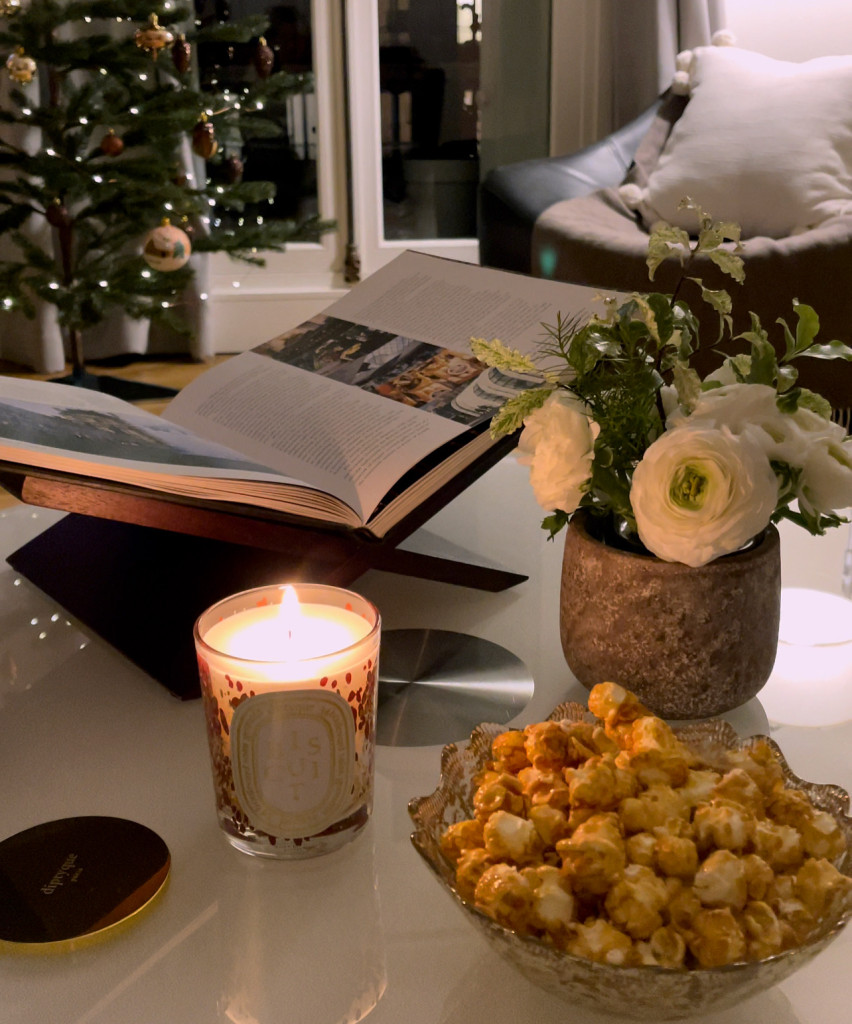 candle lit with silver bowl of popcorn